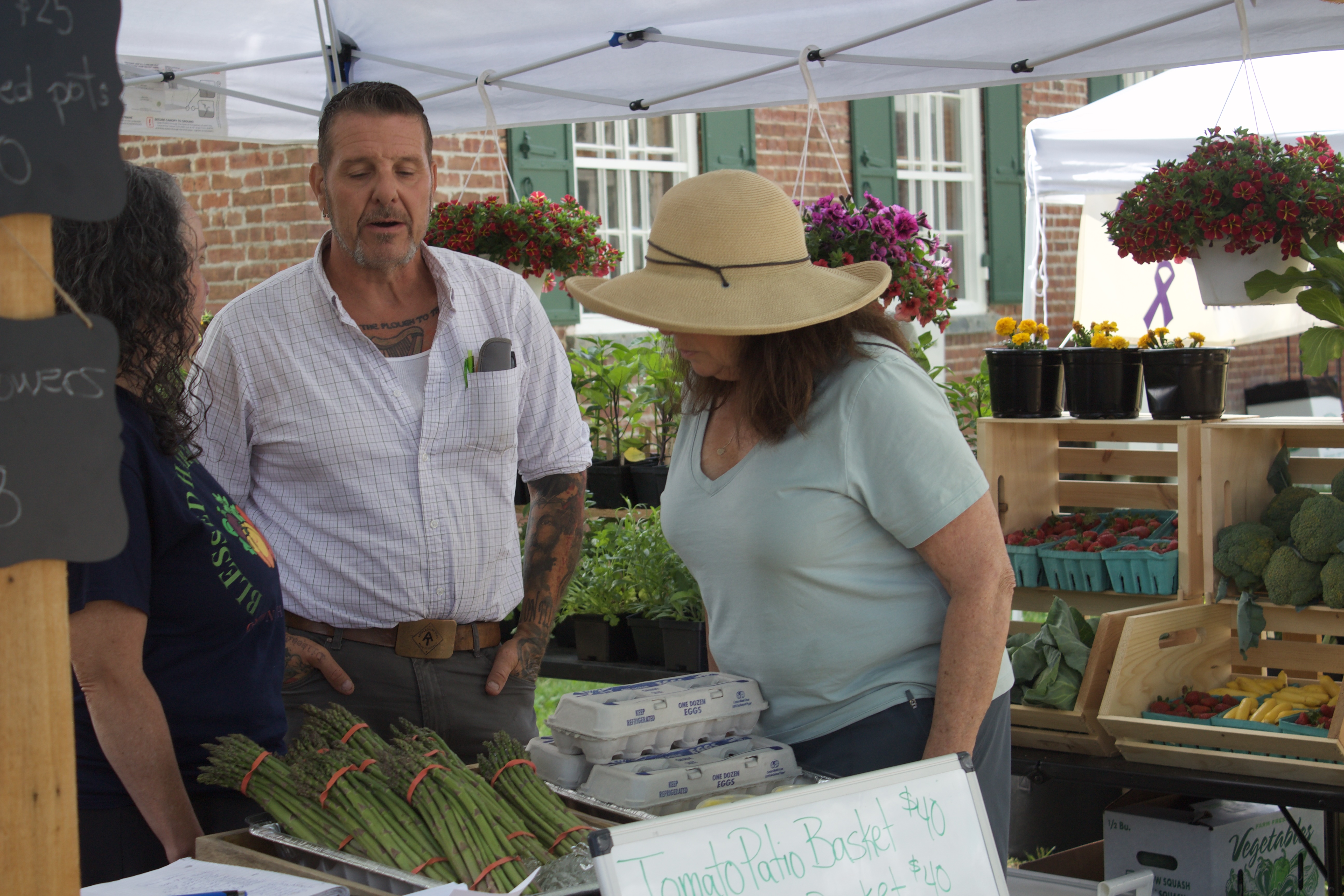 Vendors talking to attendees at May Faire