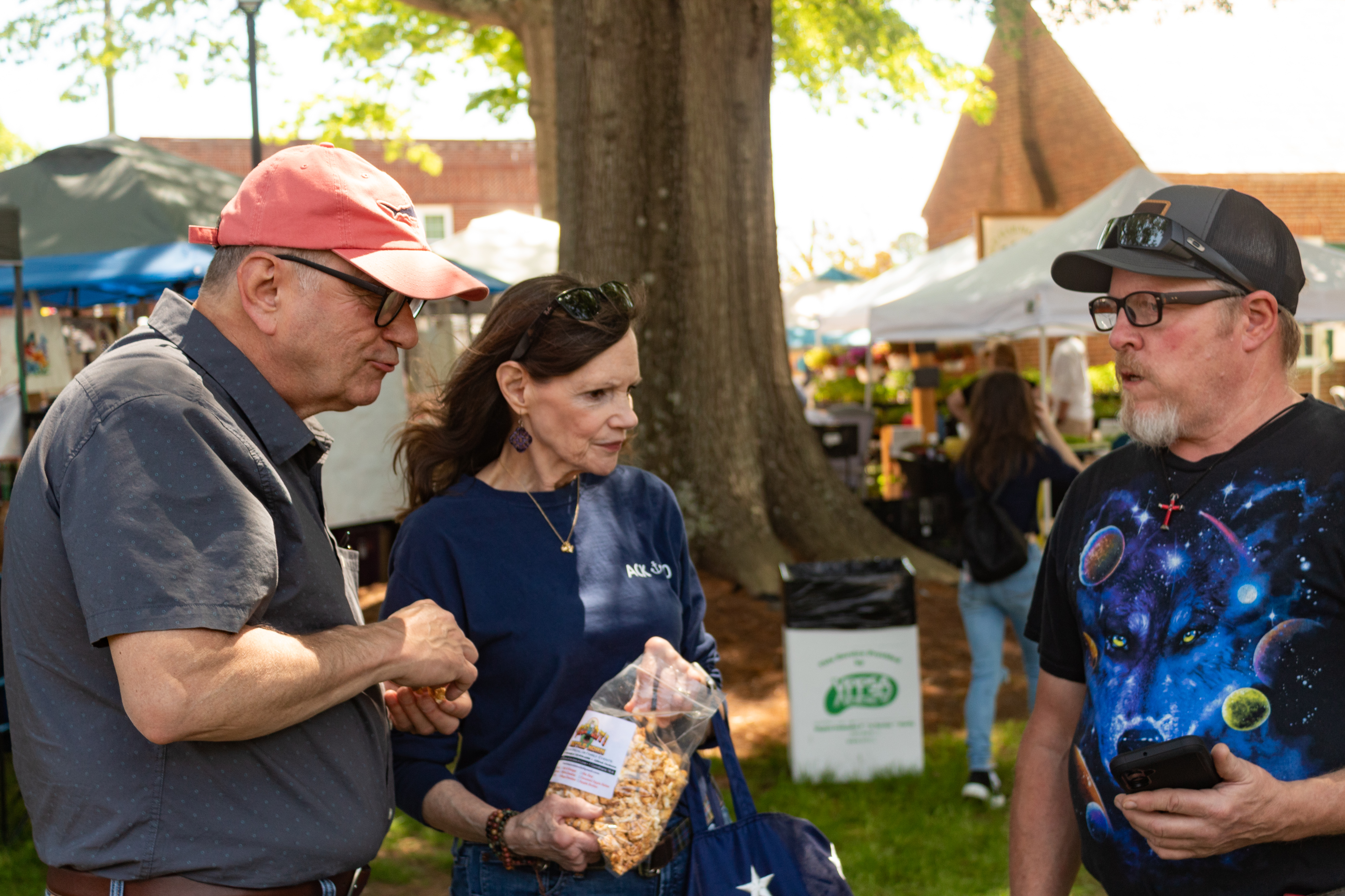 May Faire attendees talking with vendors